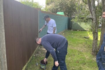 Raven team painting fences